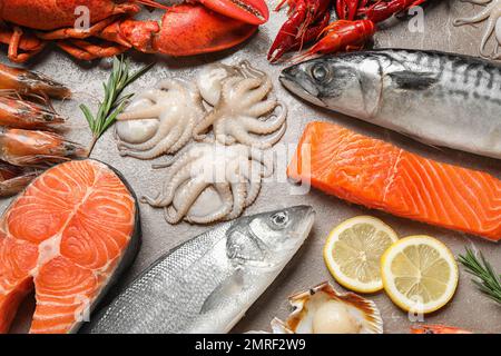 Fresh fish and seafood on marble table, flat lay Stock Photo