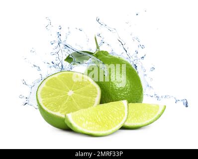 Ripe limes, fresh mint and splashing water on white background Stock Photo
