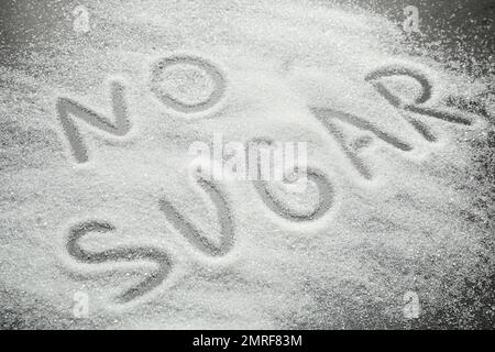 Composition with phrase NO SUGAR on grey table Stock Photo
