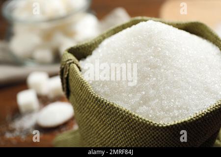 Granulated sugar in sack on table, closeup Stock Photo