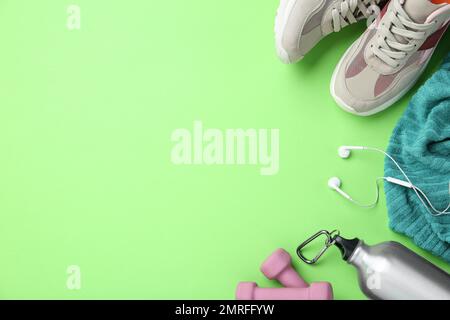 Flat lay composition with sport items on green background. Space for text Stock Photo