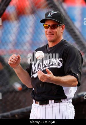 Former Miami Marlins player Jeff Conine, center, holds a jersey from 2017  as he speaks to fans with former players Luis Aquino, left, and Gaby  Sanchez, right, during a Miami Marlins baseball