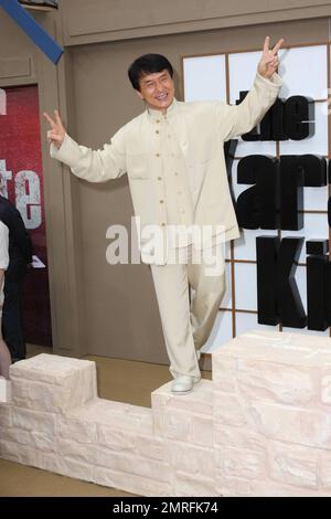 Jackie Chan walks the red carpet and poses on a prop at the premiere of 'The Karate Kid' held at Grauman's Chinese Theatre.  Chan, who is known for his long career in kung fu films, plays the role of mentor Mr. Han in the remake of the 1984 film of the same title.  The original star of the popular film, Ralph Macchio, was also at the premiere . Los Angeles, CA. 06/07/10. Stock Photo