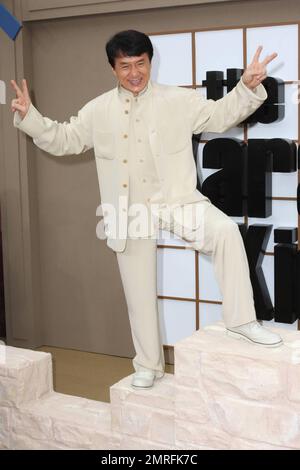 Jackie Chan walks the red carpet and poses on a prop at the premiere of 'The Karate Kid' held at Grauman's Chinese Theatre.  Chan, who is known for his long career in kung fu films, plays the role of mentor Mr. Han in the remake of the 1984 film of the same title.  The original star of the popular film, Ralph Macchio, was also at the premiere . Los Angeles, CA. 06/07/10. Stock Photo