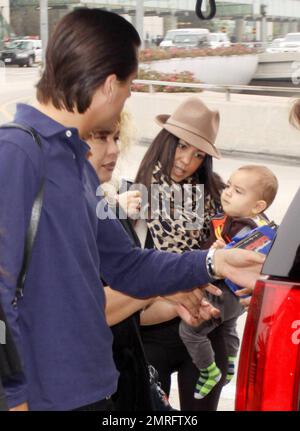 EXCLUSIVE!! Reality TV stars and fashionista sisters Kim and Kourtney  Kardashian got dolled up for their trip to the airport with Kim's beau Scott  Disick, their baby son Mason, the nanny and