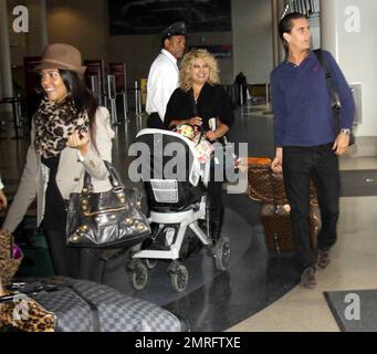 A member of LAX airport staff carries Kourtney Kardashian's navy blue  Hermes handbag Featuring: Atmosphere Where: Los Angeles, CA, United States  When: 01 May 2013 Stock Photo - Alamy
