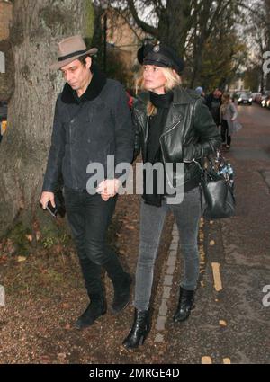 Supermodel Kate Moss and rocker husband Jamie Hince of 'The Kills' were seen walking hand in hand as they arrived at their new home in Hampstead. Its been reported that Kate paid out an estimated $30,000 at The Hoping Foundation Benefit to hear Boy George sing her favorite song. Kate got up from her table and joined Boy George in singing 'Do You Really Want To Hurt Me,' after shelling out the money for the privilege. London, UK. 23rd November 2011. Stock Photo