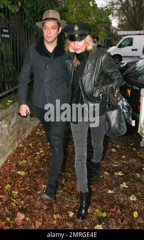 Supermodel Kate Moss and rocker husband Jamie Hince of 'The Kills' were seen walking hand in hand as they arrived at their new home in Hampstead. Its been reported that Kate paid out an estimated $30,000 at The Hoping Foundation Benefit to hear Boy George sing her favorite song. Kate got up from her table and joined Boy George in singing 'Do You Really Want To Hurt Me,' after shelling out the money for the privilege. London, UK. 23rd November 2011.   . Stock Photo