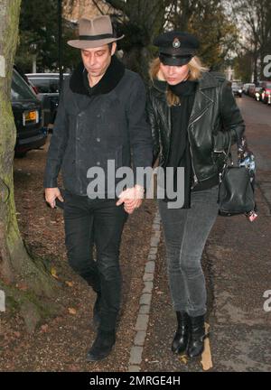 Supermodel Kate Moss and rocker husband Jamie Hince of 'The Kills' were seen walking hand in hand as they arrived at their new home in Hampstead. Its been reported that Kate paid out an estimated $30,000 at The Hoping Foundation Benefit to hear Boy George sing her favorite song. Kate got up from her table and joined Boy George in singing 'Do You Really Want To Hurt Me,' after shelling out the money for the privilege. London, UK. 23rd November 2011. Stock Photo