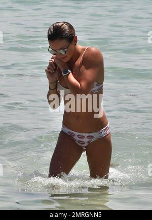 Katie Cassidy shows off her toned figure in a tan bikini as she relaxes