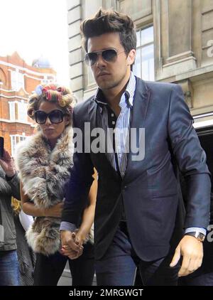 Katie Price and new boyfriend, model Leandro Penna, leave BBC Radio 2. With her hair in curlers, Katie (aka Jordan) wore a fur vest, black leggings and some funky skull-patterned high heels as the two left the building hand-in-hand. Katie, who recently split from husband Alex Reid after less than a year of marriage, has reportedly signed a $1.3 million deal to host a new reality series called 'Make Me a Hunk,' in which she will help to transform 'nerdy' men into hunks. London, UK. 3/22/11. Stock Photo