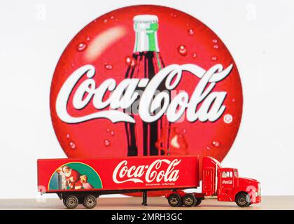 Germany. 01st Feb, 2023. In this photo illustration, a model of a Christmas truck Coca-Cola on the background of the company logo on the monitor screen. Credit: SOPA Images Limited/Alamy Live News Stock Photo