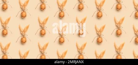 Many Easter egg with bunny ears on beige background. Pattern for design Stock Photo