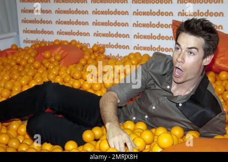 Host of Nickelodeon Australia's Kids Choice Awards 2010, US actor Jerry Trainor clowns around in a ball pit with Miss Singapore finalist Karen Wong prior to the event. Sydney, Australia. 10/8/10. Stock Photo