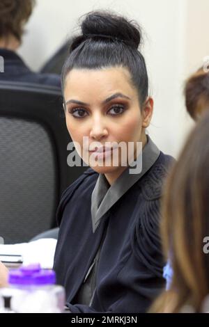 Wearing a black cape over her grey top and carrying a black Louis Vuitton  handbag, Kim Kardashian is joined by Pussycat Dolls founder Robin Antin for  a day of luxury. The two stopped in at a nail salon for a manicure and did  some shopping at Hermes and