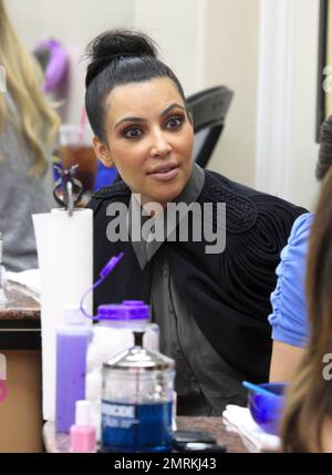 Wearing a black cape over her grey top and carrying a black Louis Vuitton  handbag, Kim Kardashian is joined by Pussycat Dolls founder Robin Antin for  a day of luxury. The two stopped in at a nail salon for a manicure and did  some shopping at Hermes and