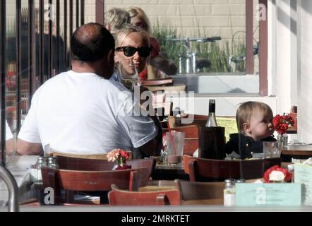 Looking casual in a plaid shirt with her hair down, Kimberly Stewart takes her daughter Delilah along as she has lunch with a male friend at the Newsroom. Little Delilah looked very cute in a black button-up overcoat. Los Angeles, CA. 5th October 2012. Stock Photo