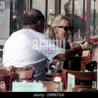 Looking casual in a plaid shirt with her hair down, Kimberly Stewart takes her daughter Delilah along as she has lunch with a male friend at the Newsroom. Little Delilah looked very cute in a black button-up overcoat. Los Angeles, CA. 5th October 2012. Stock Photo