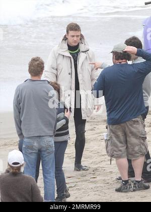 Mila Kunis wraps up in a sweater and Justin Timberlake bundles up in a big parka in between takes while filming scenes for 'Friends with Benefits' on location.  Timberlake must have been chilly as he spent most of the afternoon in the ocean riding a jet-ski. Los Angeles, CA. 09/07/10. Stock Photo