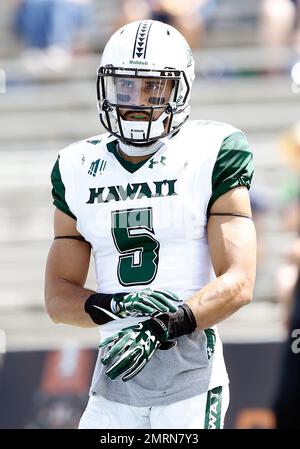 Hawaii wide receiver John Ursua (5) reaches toward the end zone as Wyoming  free safety Andrew Winged (28) during their game Saturday, Sept. 23, 2017.  (Josh Galemore/The Casper Star-Tribune via AP Stock