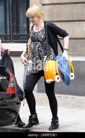 EXCLUSIVE!! In final preparations for her new baby, Pregnant Radio 6 DJ and TV presenter Lauren Laverne leaves the BBC carrying a baby bag patterned to look like a cat, complete with wheels. Laverne has done her best to hide her baby bump for months, but didn't seem concerned about hiding it as she made her way to her car. London, UK. 7/7/10. Stock Photo