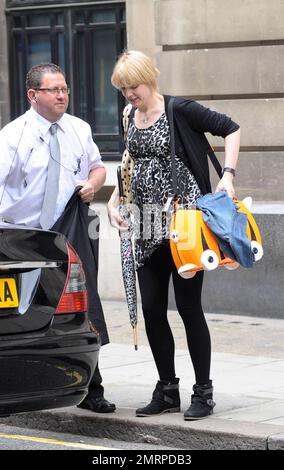 EXCLUSIVE!! In final preparations for her new baby, Pregnant Radio 6 DJ and TV presenter Lauren Laverne leaves the BBC carrying a baby bag patterned to look like a cat, complete with wheels. Laverne has done her best to hide her baby bump for months, but didn't seem concerned about hiding it as she made her way to her car. London, UK. 7/7/10. Stock Photo