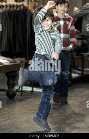 Singer LeAnn Rimes and husband, actor Eddie Cibrian, along with his sons Mason, 7, and Jake, 4, were seen shopping at the Malibu Country Mart. The country superstar wore a brown hat, brown top, blue jeans with black knee high boots and kept it warm with a grey sweater and a rusty colored scarf. 29 year old Rimes was seen joking around and being playful with her husband's sons giving each one hugs and even picking up Jake at one point. The family who appeared to be having a great time together eventually headed out in their black Porsche. Malibu, CA. 11th December 2011. Stock Photo