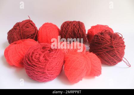 Red series of wool yarn on a white background Stock Photo