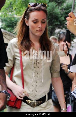 Actress Leighton Meester got a helping hand while on the set of 'Gossip Girl' filming in NYC.  As a light rain fell Meester, who wore a trendy tan jumper with gladiator sandals and a belt that accentuated her small waistline, had one of the crew hold an umbrella for her while walking with a bodyguard in between takes on the set of the hit CW teen drama TV series.  Co-star Jessica Szohr also walked with Meester at one point and wore large curlers in her hair. New York, NY. 07/13/10.   . Stock Photo