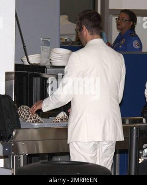 Exclusive!! Oasis Frontman Liam Gallagher looked Miami nice as he arrived at Miami airport channeling Sonny Crocket from Miami Vice. Liam was wearing a cream suit and animal print shoes as he took a flight to South America where Oasis are playing. Miami, Fl. 4/27/09.     . Stock Photo