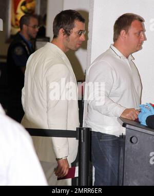 Exclusive!! Oasis Frontman Liam Gallagher looked Miami nice as he arrived at Miami airport channeling Sonny Crocket from Miami Vice. Liam was wearing a cream suit and animal print shoes as he took a flight to South America where Oasis are playing. Miami, Fl. 4/27/09.     . Stock Photo