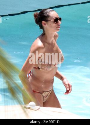 Sharlely Becker's gold bikini struggles to contain her post-baby curves and almost lost her bikini top following a swim with Boris. Miami, FL. 9/3/10. Stock Photo