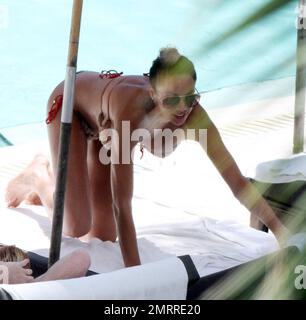 Sharlely Becker's gold bikini struggles to contain her post-baby curves and almost lost her bikini top following a swim with Boris. Miami, FL. 9/3/10. Stock Photo