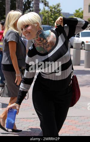EXCLUSIVE!! Showing off a tattoo on her upper chest that reads 'Fear Not,' Janine Lindemulder, ex-wife of Jesse James, leaves Family Court in Orange County, California after a hearing regarding the custody of their daughter, Sunny. According to reports, the hearing resulted in the judge rejecting Jesse's claim that Lindemulder should be denied visitation because of alleged drug problems. Los Angeles, CA. 6/18/10. Stock Photo