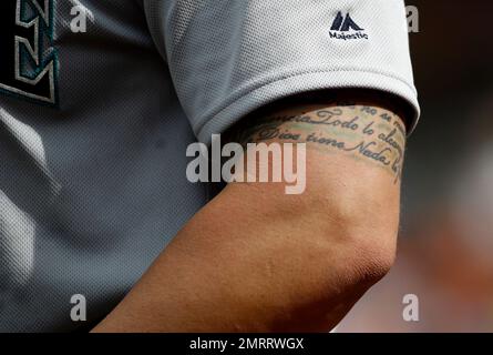A Major League Baseball tattoo is seen on the neck of Chicago Cubs
