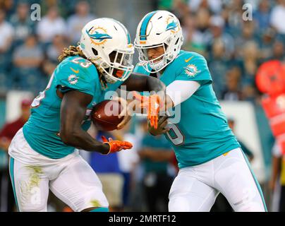Miami Dolphins quarterback Jay Cutler, middle, and Matt Moore, right, talk  to head coach Adam Gase, left, in the first half against the Los Angeles  Chargers at StuHub Center in Carson, California