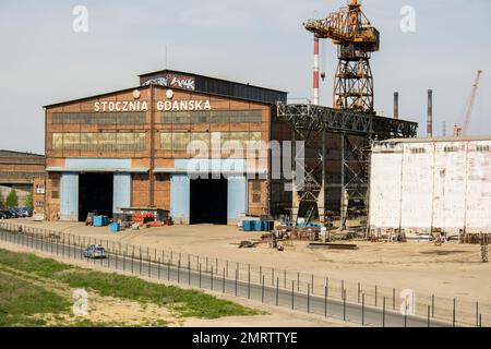 Gdansk, Poland - July 19 2022: Industrial building at the Gdansk Shipyard, former Lenin Shipyard, prefabrication workshop and heavy cranes large Polish shipyard. Cranes at historical shipyard in Gdansk headquarters of Solidarity Polska Stock Photo