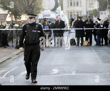 Police stand guard while neighbors and reporters gather at the Luton home where Stockholm suicide bomber suspect Taimour Abdulwahab al-Abdaly is believed to have resided prior to December 11th, the day when two bombs were detonated in Stockholm, Sweden, the second o which killed the suspected bomber who has yet to be identiied.  Police searched the Luton home ater reportedly obtaining a search warrant under the Terrorism Act 2000, and according to reports police have said that no hazardous materials have been ound and no arrests made. During the search a terrorist oicer was seen removing items Stock Photo