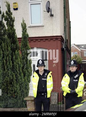 Police stand guard while neighbors and reporters gather at the Luton home where Stockholm suicide bomber suspect Taimour Abdulwahab al-Abdaly is believed to have resided prior to December 11th, the day when two bombs were detonated in Stockholm, Sweden, the second of which killed the suspected bomber who has yet to be identified.  Police searched the Luton home after reportedly obtaining a search warrant under the Terrorism Act 2000, and according to reports police have said that no hazardous materials have been found and no arrests made. During the search a terrorist officer was seen removing Stock Photo