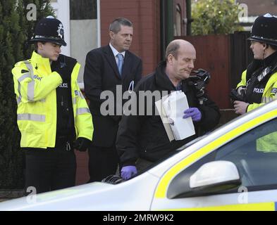 Police stand guard while neighbors and reporters gather at the Luton home where Stockholm suicide bomber suspect Taimour Abdulwahab al-Abdaly is believed to have resided prior to December 11th, the day when two bombs were detonated in Stockholm, Sweden, the second of which killed the suspected bomber who has yet to be identified.  Police searched the Luton home after reportedly obtaining a search warrant under the Terrorism Act 2000, and according to reports police have said that no hazardous materials have been found and no arrests made. During the search a terrorist officer was seen removing Stock Photo