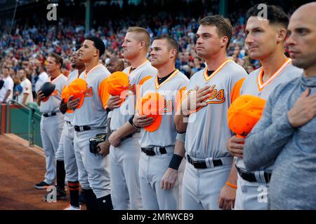 Baltimore Orioles players stand for the National Anthem of Canada and the  United States prior to the start of the Toronto Blue Jays at Baltimore Orioles  spring training baseball game at Ed