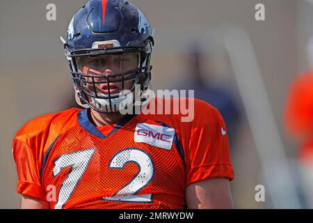 FILE - Denver Broncos offensive line consultant Alex Gibbs, back, looks on  as linemen take part in drills after the morning session at the team's NFL  training camp in Englewood, Colo., in