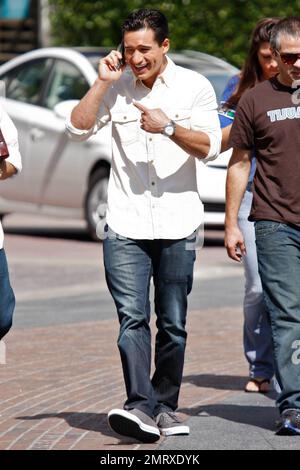 New dad actor and TV personality Mario Lopez has a smile from ear to ear as he arrives at The Grove shopping center to work on the American TV show 'Extra' where actress Olivia Newton-John and actor Chevy Chase were interviewed.  Lopez's girlfriend Courtney Mazza gave birth to their first child, daughter Gia Francesca Lopez on September 11th.  Los Angeles, CA. 10/07/10. Stock Photo