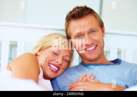 Joyful middle aged couple spending time together. Portrait of a joyful middle aged couple spending time together. Stock Photo