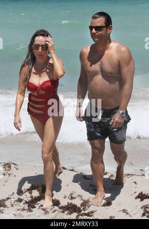 'The Real Housewives Of Miami' star Marysol Patton and a male friend enjoy the beach and ocean. Miami Beach, FL. 28th of May, 2012. Stock Photo