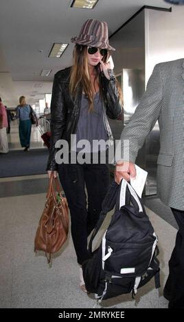 Actress Megan Fox was seen arriving at LAX this morning for a flight to New Orleans where she is filming the comic book western, 'Jonah Hex.'  Fox wore a striped fedora hat and ripped jeans.  As fox walked through the terminal she made a gesture with her pinky very reminiscent of the character Mini Me in the 'Austin Powers' films.  Los Angeles, CA.  5/9/09. Stock Photo