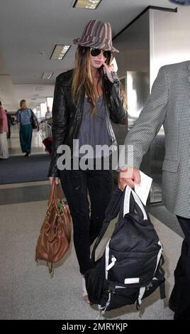 Actress Megan Fox was seen arriving at LAX this morning for a flight to New Orleans where she is filming the comic book western, 'Jonah Hex.'  Fox wore a striped fedora hat and ripped jeans.  As fox walked through the terminal she made a gesture with her pinky very reminiscent of the character Mini Me in the 'Austin Powers' films.  Los Angeles, CA.  5/9/09. Stock Photo