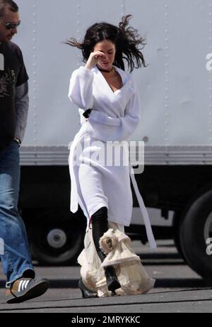 Exclusive!! Megan Fox films on location in Sylmar, CA this morning.  She was seen walking to the set with a white robe covering a frilly cowboy-western style dress, complete with boots and garter.  Fox plays Leila in the upcoming western movie, 'Jonah Hex,' also starring Josh Brolin.  Los Angeles, CA. 4/3/09. Stock Photo