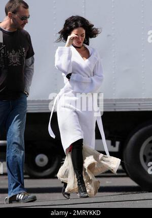 Exclusive!! Megan Fox films on location in Sylmar, CA this morning.  She was seen walking to the set with a white robe covering a frilly cowboy-western style dress, complete with boots and garter.  Fox plays Leila in the upcoming western movie, 'Jonah Hex,' also starring Josh Brolin.  Los Angeles, CA. 4/3/09. Stock Photo