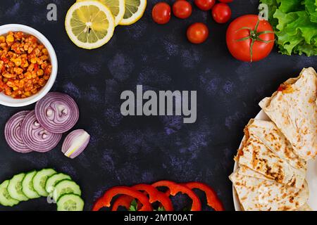 A top view of quesadilla with chicken and corn on dark background Stock Photo